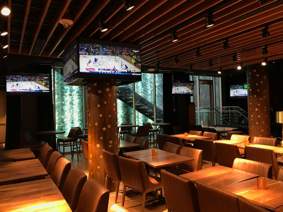 A restaurant interior with warm Ketra lighting illuminating the space.