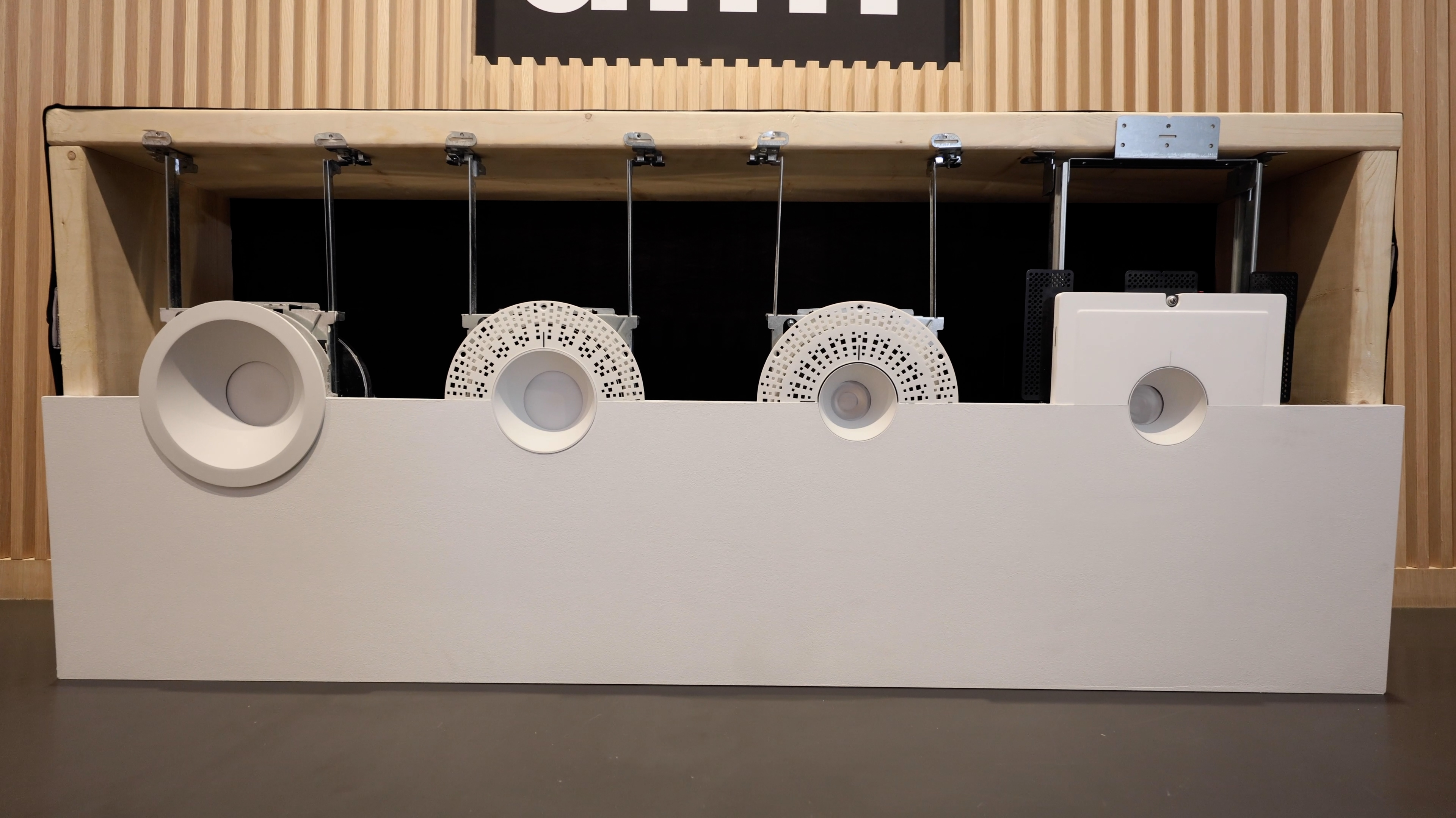 A display of various DMF lighting trims showcasing different colors and finishes for home installations.