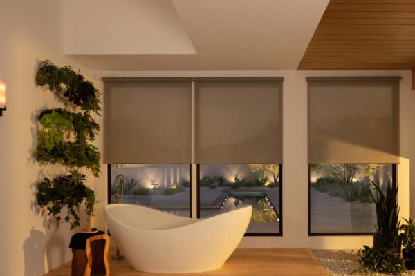 Relaxing bathroom with freestanding tub, wooden ceiling, and wall-mounted plants