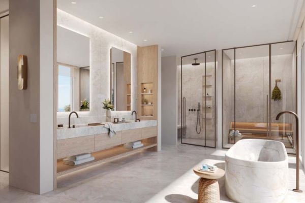 Bright modern bathroom with large mirrors, marble finishes, and glass shower enclosures