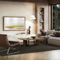 Walnut Leon Studio Frame TV displaying landscape art above a marble console table in a modern living room with forest views.