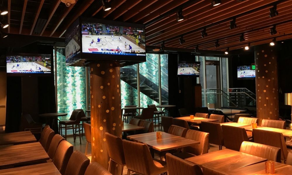 A restaurant interior with warm Ketra lighting illuminating the space.