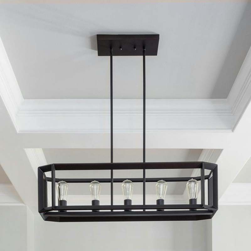 A suspended rectangular cage-style chandelier featuring multiple bulbs, installed in a spacious entryway or dining area.